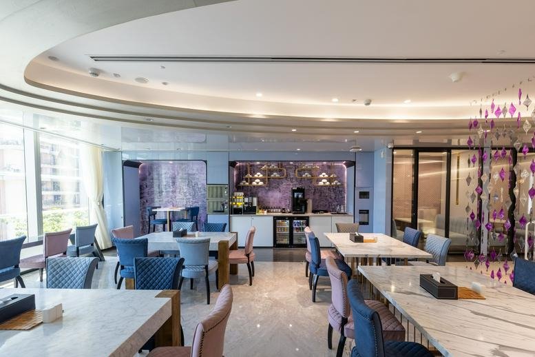 Spacious communal lounge at Level 1 & 3A, First International Financial Centre with modern colorful seating.