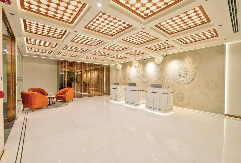 Grand reception area of Fortius Tower, Level 5, Olympia Tech Park with ornate gold coffered ceilings.