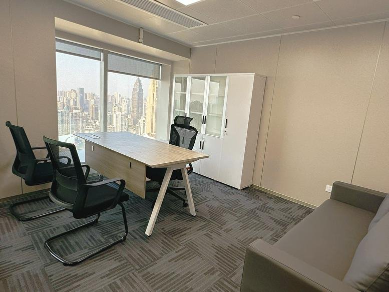 Private office at Fukang Building with a wooden desk, black ergonomic chairs, and panoramic city views.