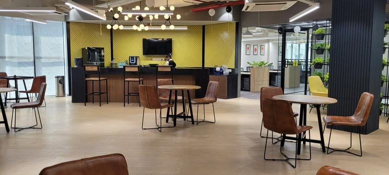Cafe area with a yellow feature wall and leather seating at Silverton Towers.