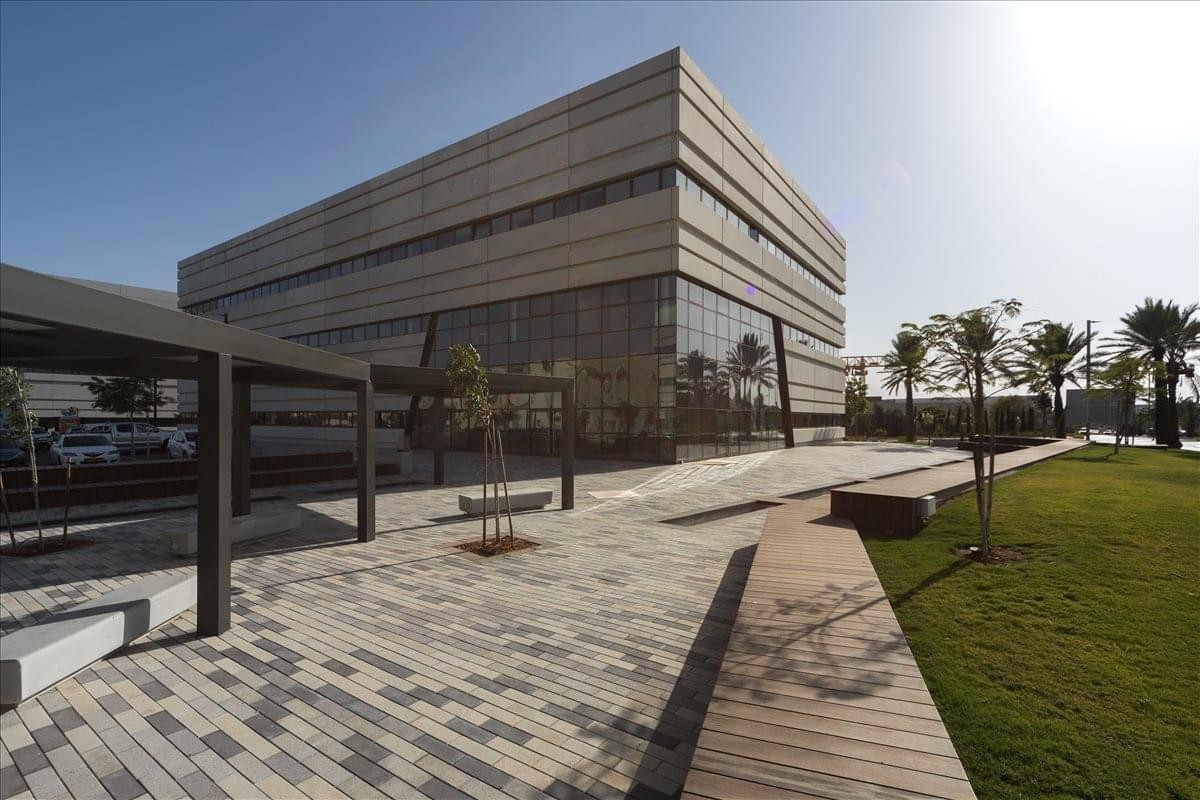 Exterior view of the modern stone and glass building at HaEshel St 2.