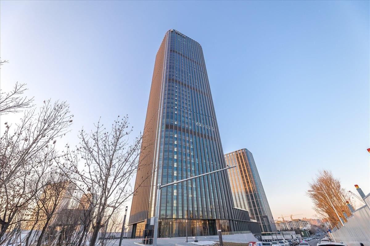 Exterior view of the glass-facade Hairong Plaza building against a clear blue sky.