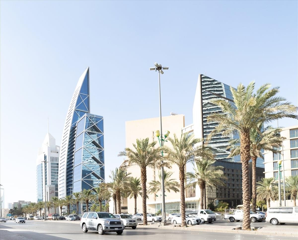 Street-level view of the modern Hamad Tower and surrounding high-rise buildings.