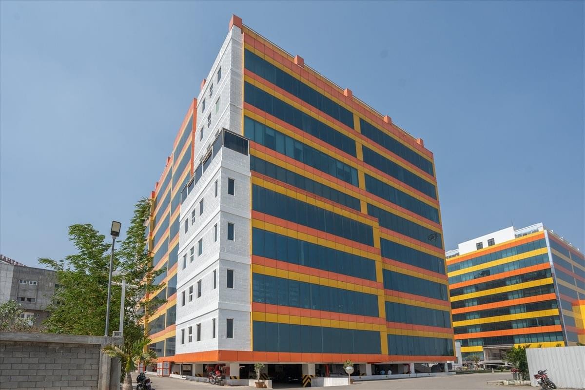 Exterior view of the multi-story Hanudev Info tech Park, Udaiyampalayam Road, Nava India, Coimbatore.