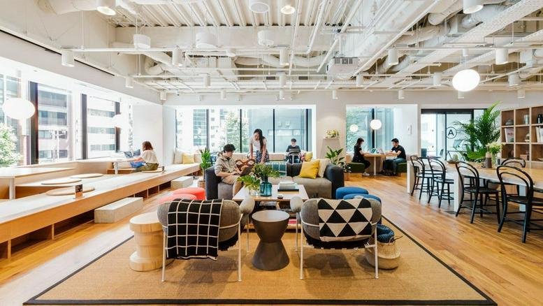 Spacious communal lounge at Hanzomon PREX featuring colorful armchairs and an open industrial ceiling.