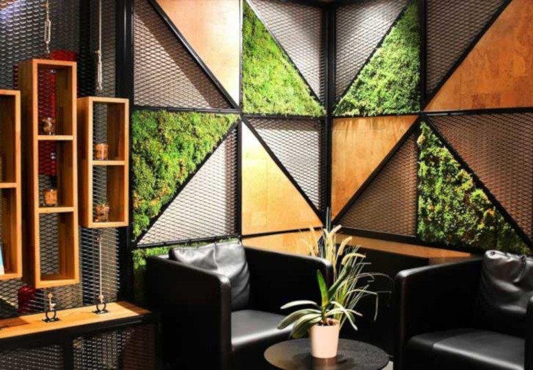 Breakout area with geometric wall patterns of moss and wood at Hasat Sk, 52, Merkez Mh, Şişli, Istanbul.