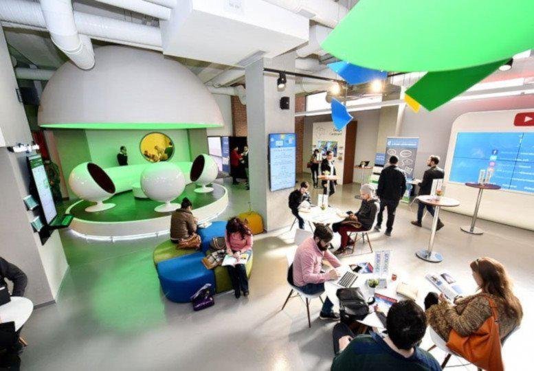 Spacious coworking hub at Hasat Sk, 52 with futuristic white seating and colorful hanging decor.