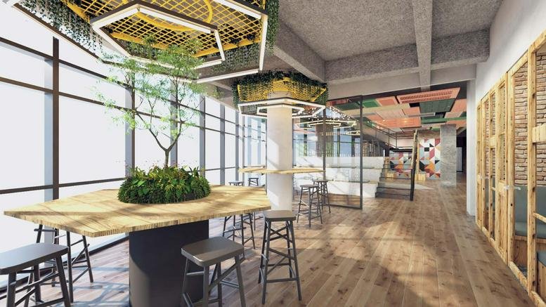 Coworking area at HaShlosha 4, Tel Aviv with hexagonal ceiling lights and wooden tables.