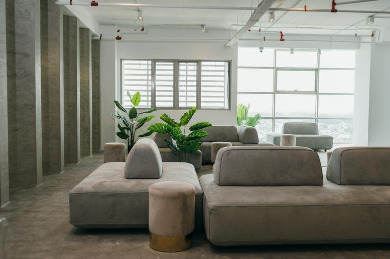 Spacious lounge area with modular grey seating and large windows at Southern Tower First Subang.