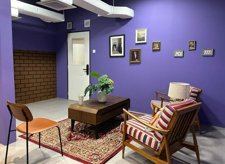 Brightly lit lounge at No. 63 (Level 2), Jalan SS2/64, Petaling Jaya with purple walls and patterned armchairs.