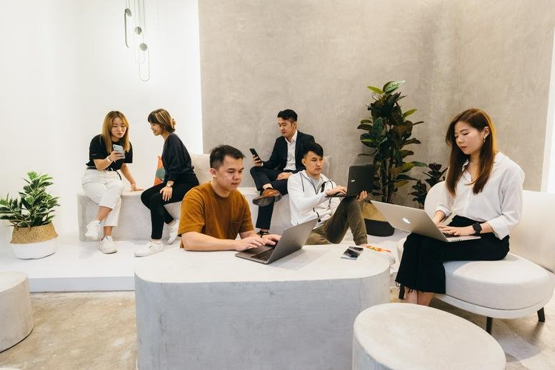 Spacious communal lounge at No. 8A (Level 1), Jalan Wan Kadir 1 featuring plants and coworking groups.