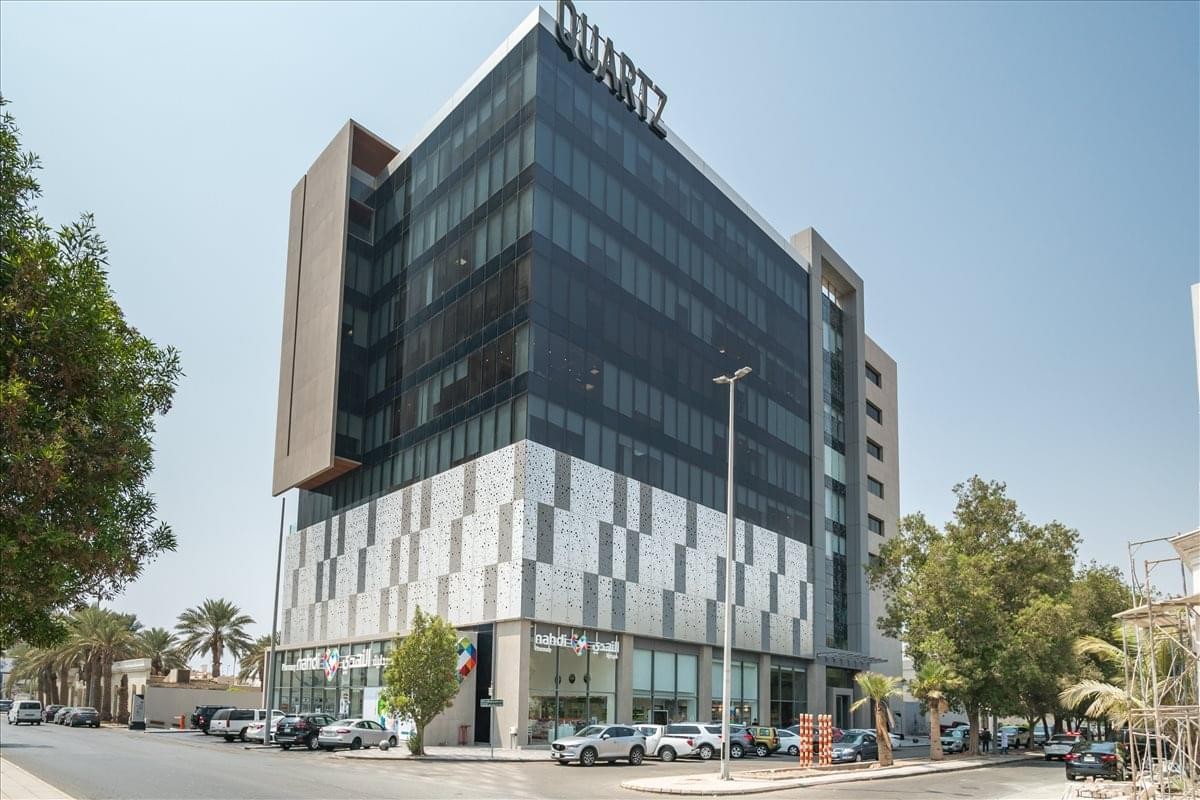 Exterior view of the modern glass-facade Quartz building on Ash Shati Road.