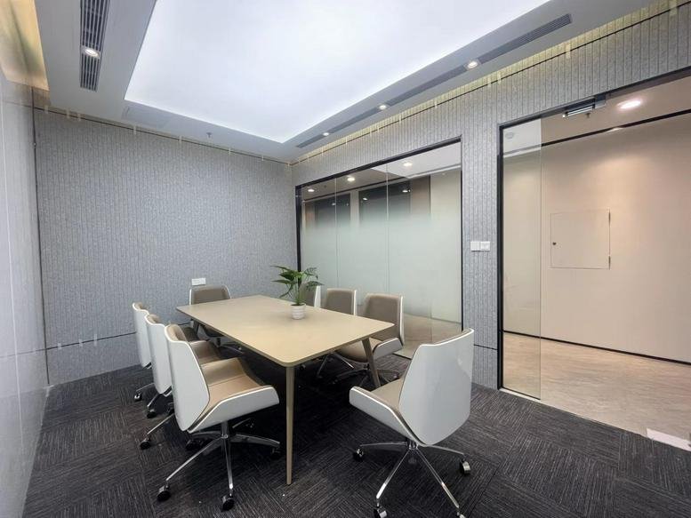 Meeting room with a large wooden table and grey chairs at Jiaodian Building.