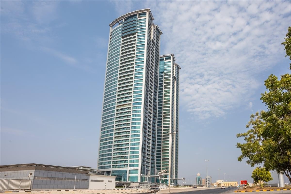 Exterior view of the twin glass-facade skyscrapers of Julphar Tower RAK.