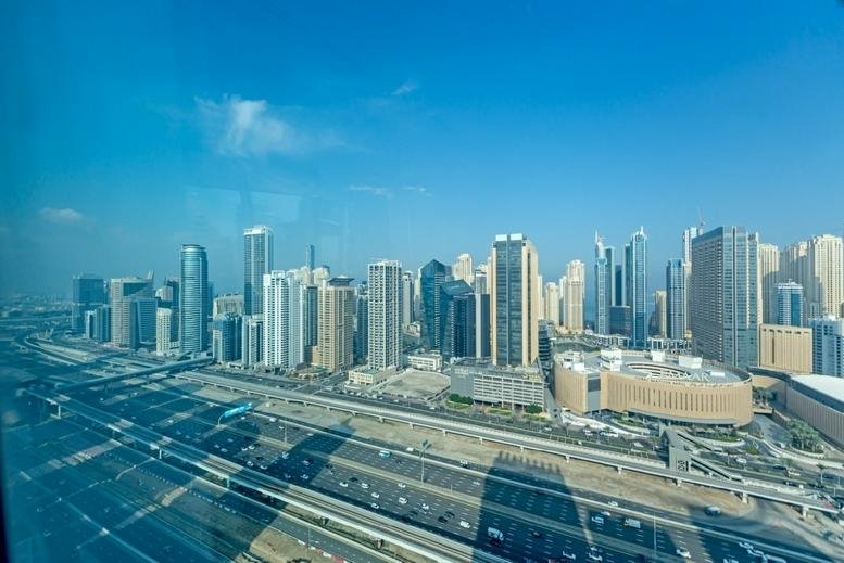High-angle view of the urban skyline and highway from Reef Tower, 28th Floor, Cluster O, Jumeirah Lake Towers.
