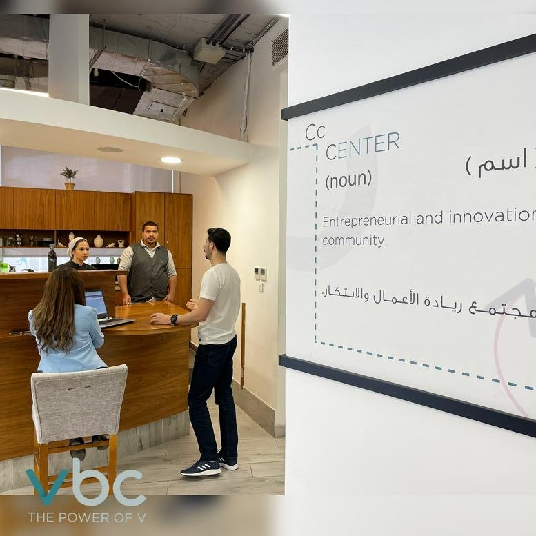 Reception area at Khalda, Princess Zeinab Bent Al-Hussein Street, Amman featuring a wood-paneled desk and wall graphics.