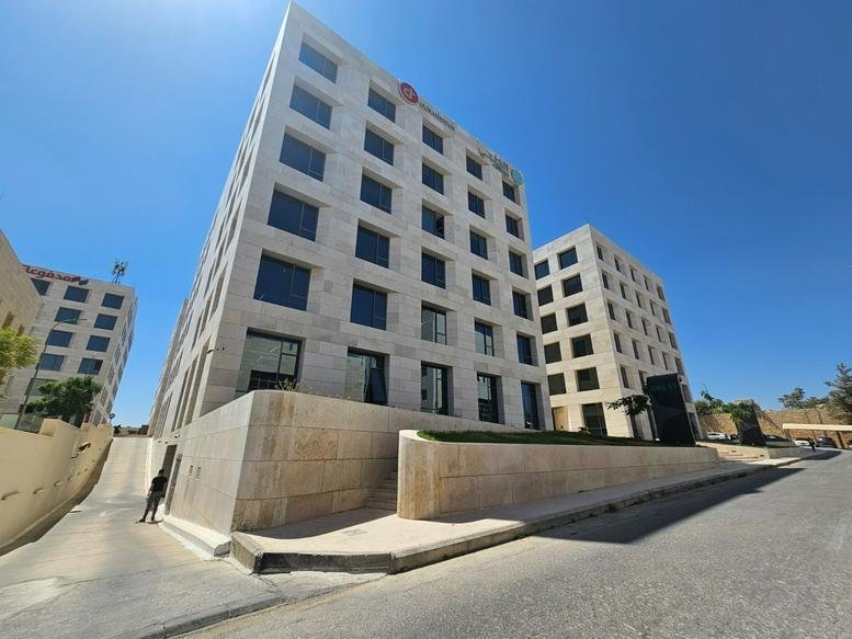 Exterior view of the modern stone-clad facade of Hive Building Number 15 at KHBP.