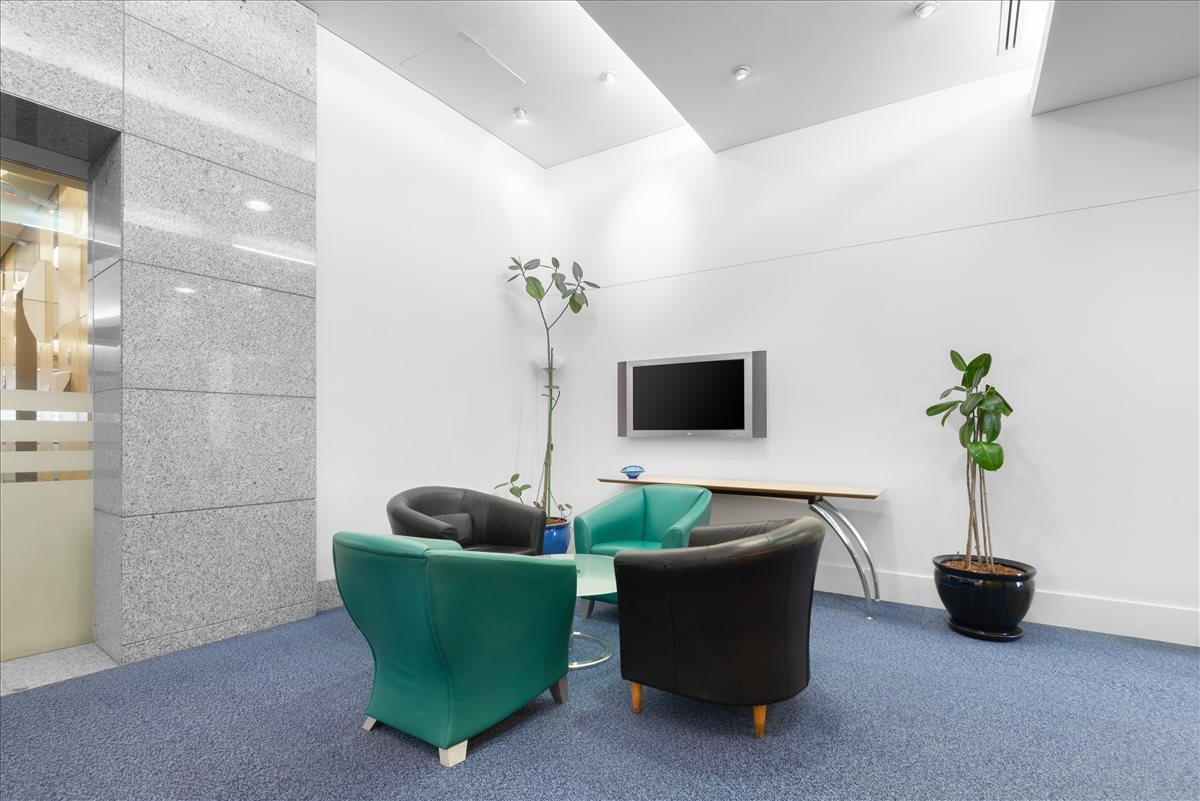 Lounge area with green and black armchairs at the King Fahd Road, Kingdom Center.