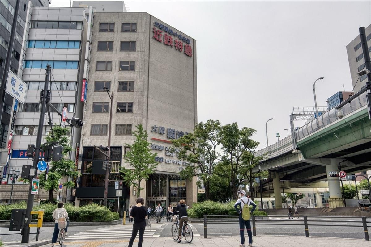 Exterior view of the multi-story Kintetsu Namba Build 1-3F located on a busy street corner.