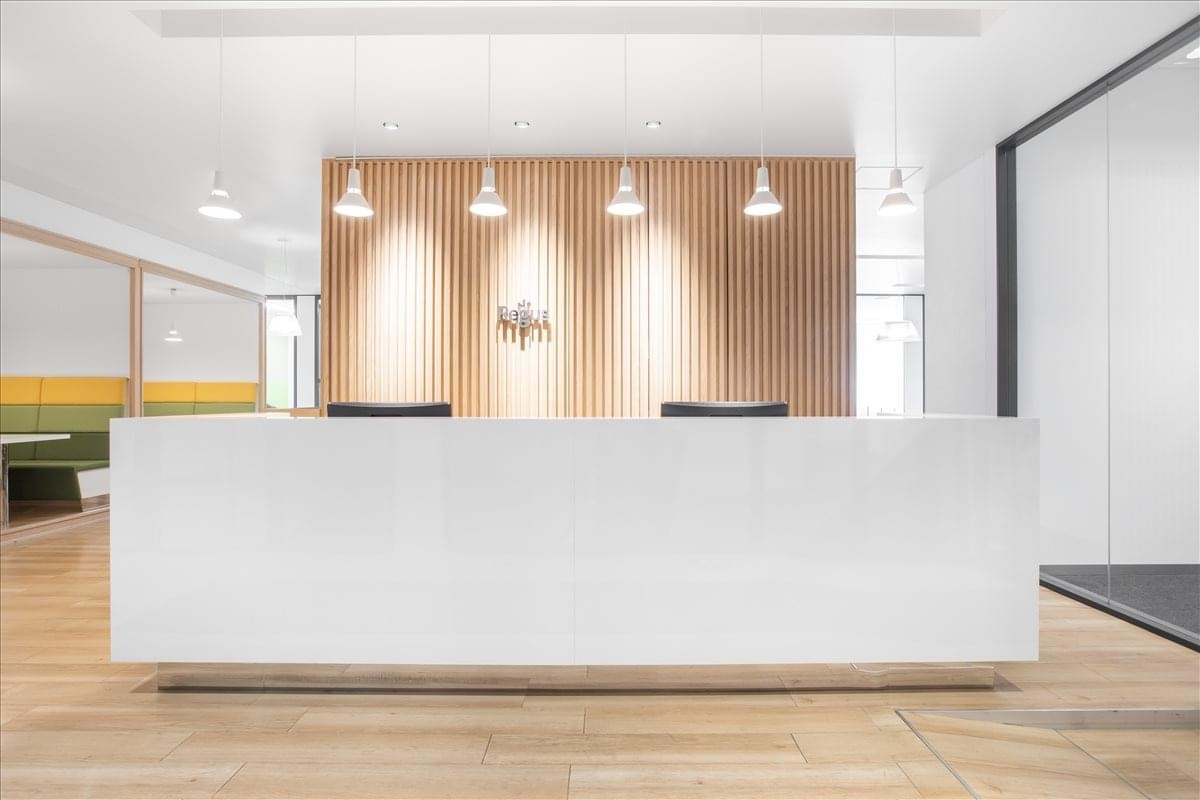 Modern reception desk at Kurax Sendai 4F, 3-3-1 Ichibancho with warm wood paneling and pendant lighting.