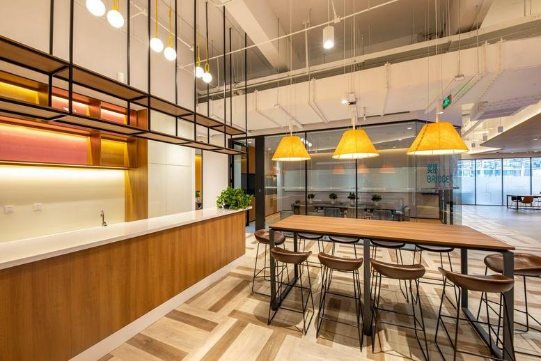 Spacious communal breakout area at L1, Block 1, DAITP, No. 1 Huixian Park with a breakfast bar and pendant lights.