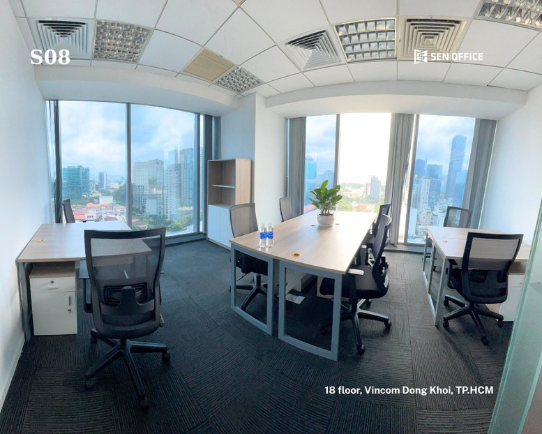 Spacious interior office at Vincom Center with multiple desks, potted plants, and panoramic city views.