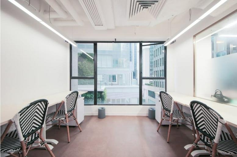 L3 World Trust Tower bright workspace with linear lighting and patterned chairs.