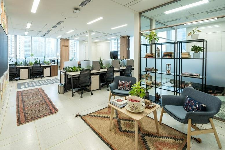 Stylish open-plan workspace at L6 Peninsula Towers, Peninsula Corporate Park with varied seating and warm rugs.