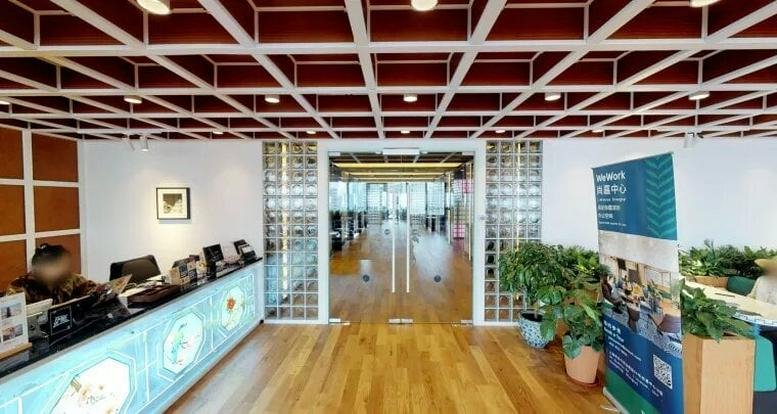 Reception area at L’Avenue Shanghai, 99 Xianxia Road with a modern red coffered ceiling and light wood floors.