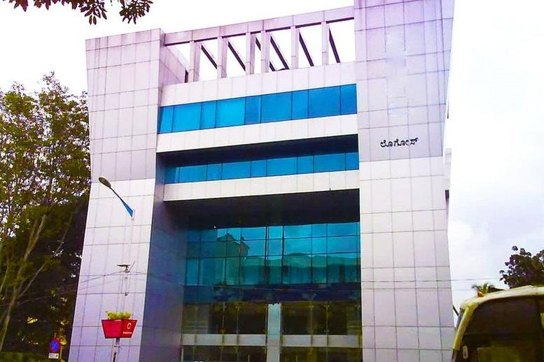 Exterior view of the modern glass-facade building at Logos, 206 Mahatma Gandhi Road.