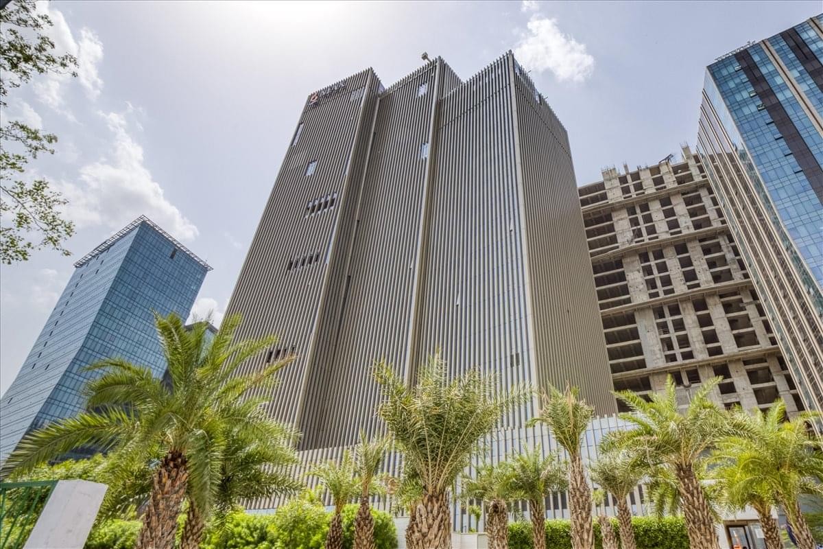 Exterior view of the modern glass and steel facade of Max Towers.