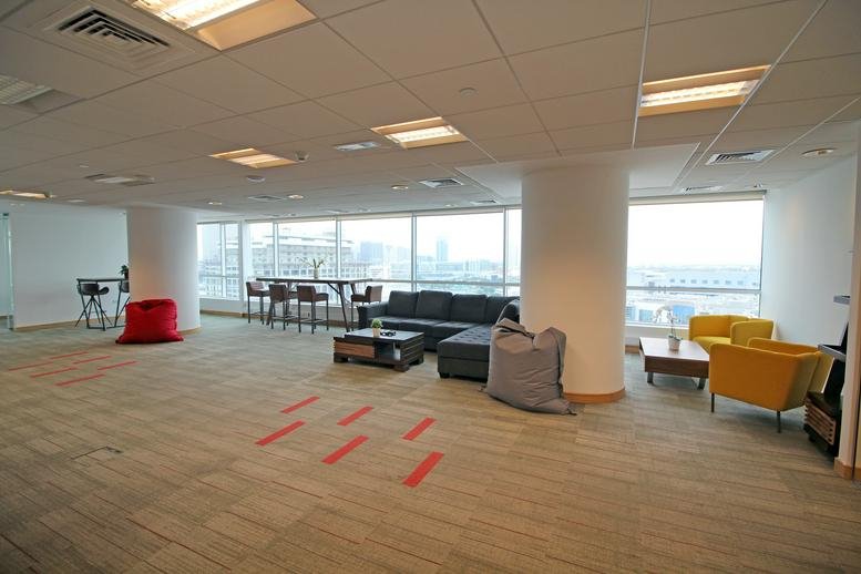 Spacious communal breakout area at Concord Tower with varied seating and large windows.