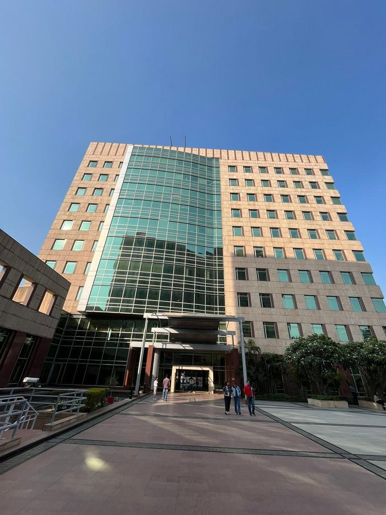 Exterior view of the glass and stone facade at Tower A, Global Business Park.