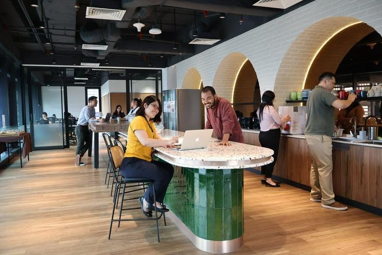 Spacious coworking cafe with green tiled counters and arched alcoves at Menara 1 Sentrum.