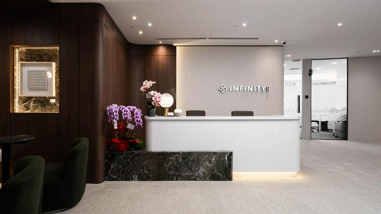 Main reception desk at Menara Southpoint featuring a minimalist white counter and marble accents.