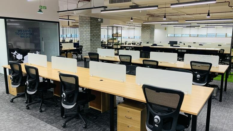 Spacious open-plan workspace at My Home Hub, Block 1, Level 5 with rows of wooden desks.