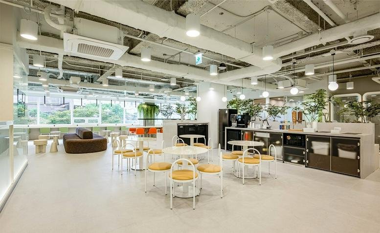 Spacious communal lounge at Myeongdong Branch, 16 Namdaemun-ro 7-gil, Seoul with modern seating and cafe area.