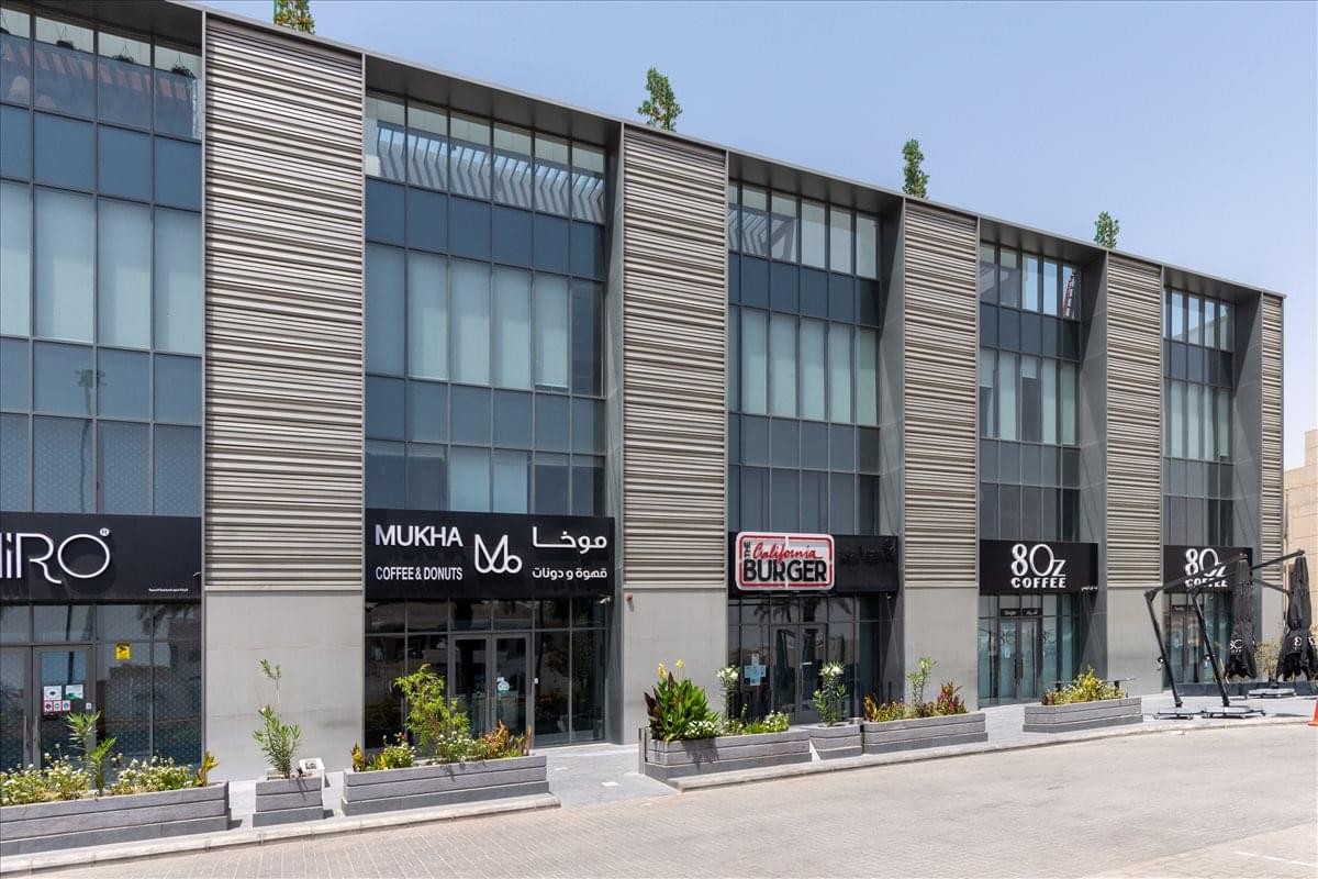 Modern multi-story exterior view of the glass-fronted Nawwaf Square building.