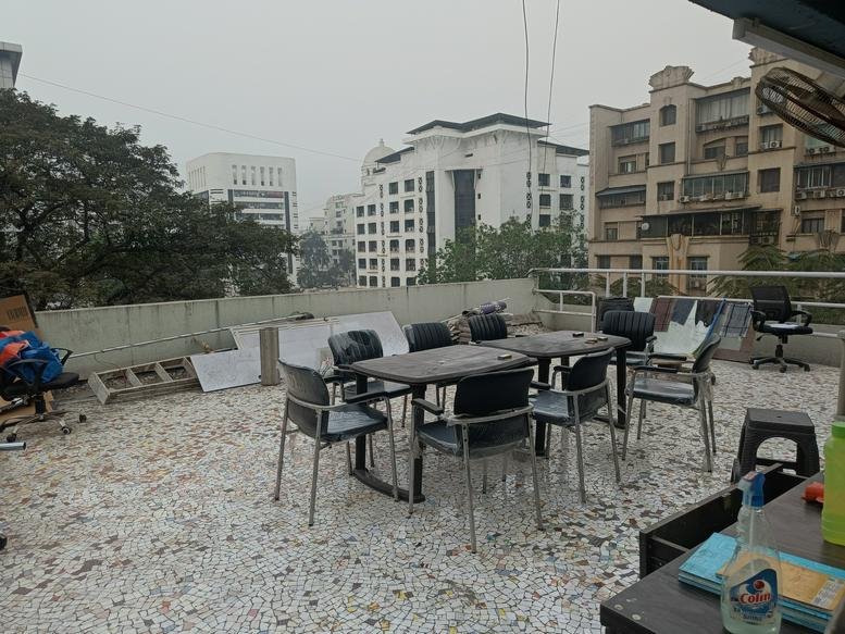 Spacious rooftop terrace at NBC Complex, Sector 11, Navi Mumbai with outdoor tables and city views.
