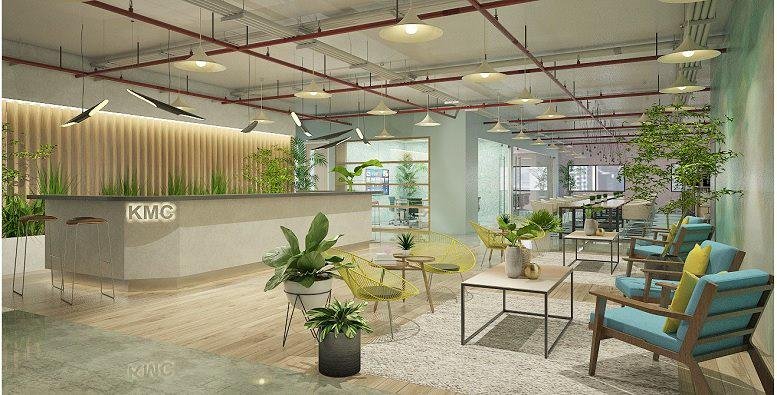 Spacious reception and lounge at NET Quad with warm lighting, wooden accents, and indoor greenery.