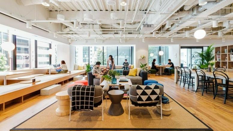 Spacious sunlit lounge and coworking hub at Nihonbashi Kabuto One with various seating and exposed ceilings.