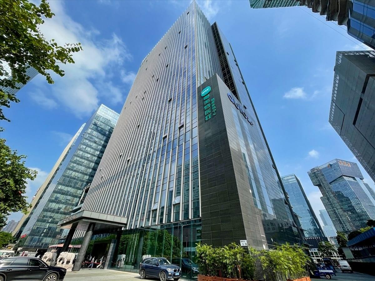 Low-angle exterior view of the glass-facade IMT Building at No. 1 Gaoxin South 7th Road.