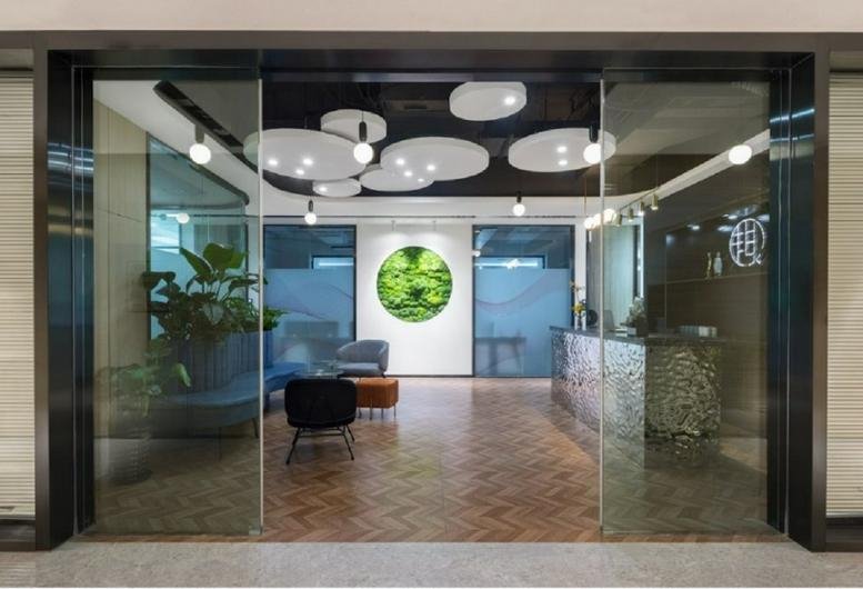 Reception and lobby area at China Resources Building with circular ceiling lights and wood flooring.