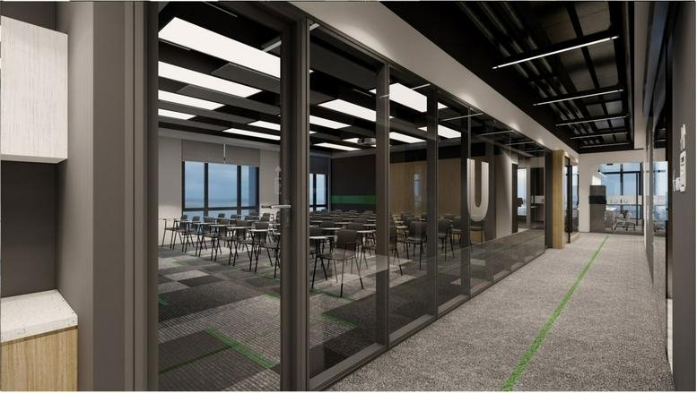 Spacious interior of Tieqiao Plaza featuring a glass-walled training room and industrial ceiling.