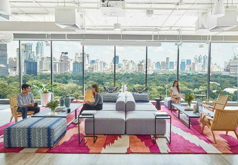 Spacious lounge at No. 2 Silom Road, Silom Edge, with colorful rugs and panoramic city views.