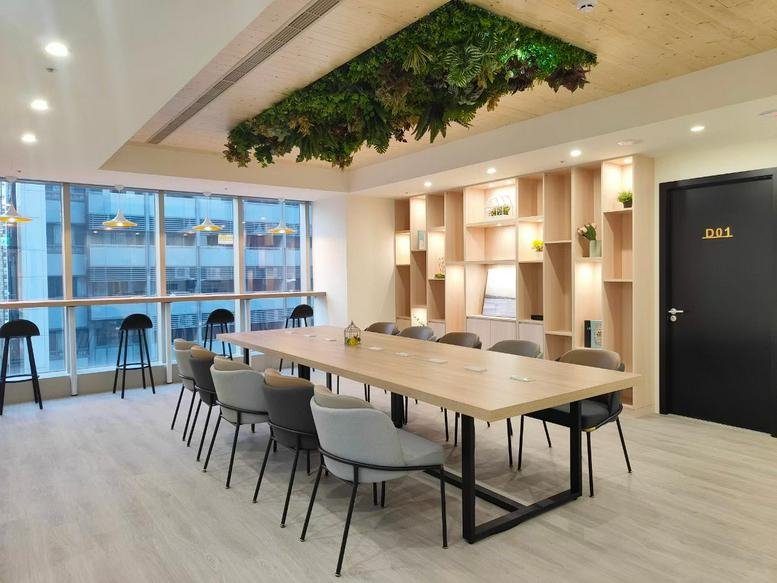 Spacious communal area at No. 62, Nanjing West Road, 7th Floor, Taipei with a long wooden table and hanging greenery.