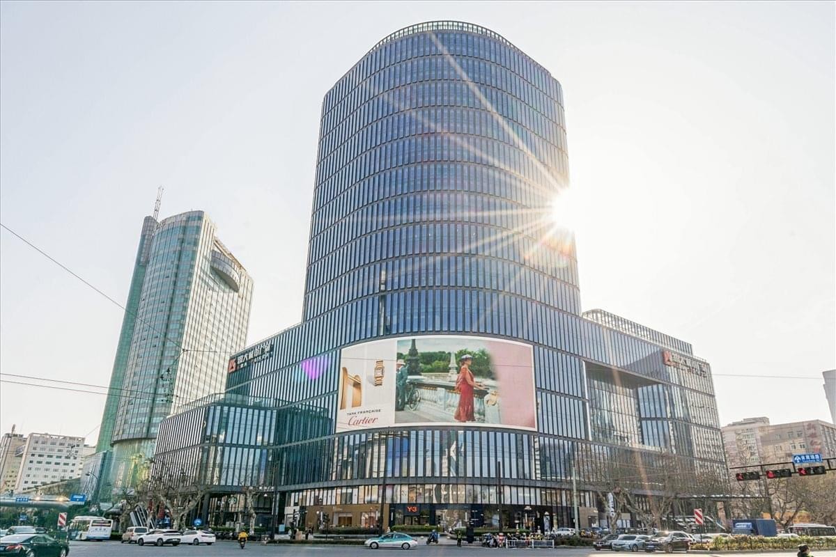 Exterior view of the GDA Plaza building with a digital screen and glass facade.