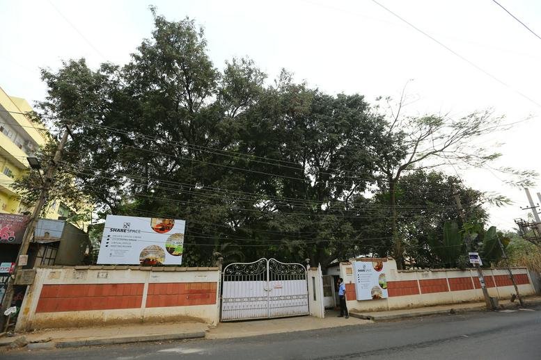 Exterior view of the white-gated entrance to the office at No. 88, Borewell Road, Whitefield, Bangalore.