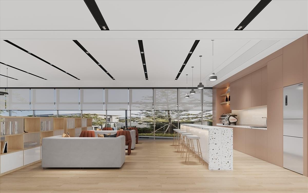 Bright communal break area at Reeb Building with a white marble island and warm wood accents.