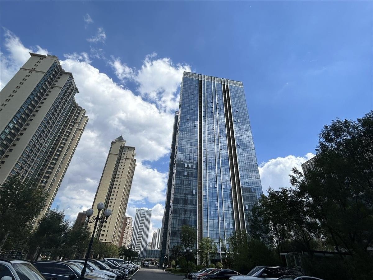 Exterior of the glass high-rise China Resources Centre building against a blue sky.